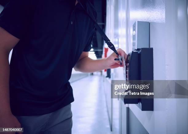 midsection of man using security card to enter room in data center - keycard access stock pictures, royalty-free photos & images