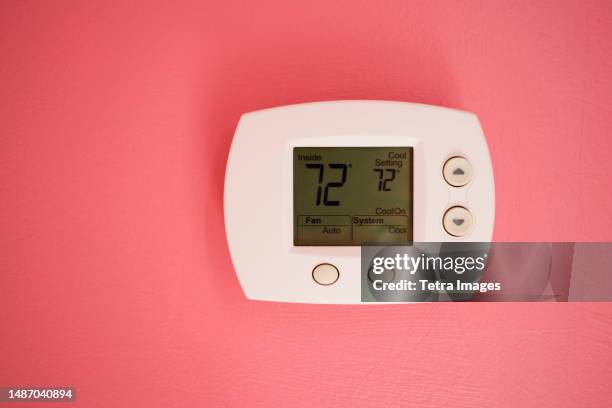 wall thermostat at 72 degrees fahrenheit - fahrenheit stock pictures, royalty-free photos & images