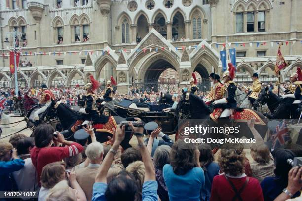 Queen Elizabeth II and Earl Spencer make their way by coach to Buckingham Palace after the wedding of Prince Charles and Lady Diana Spencer, London,...