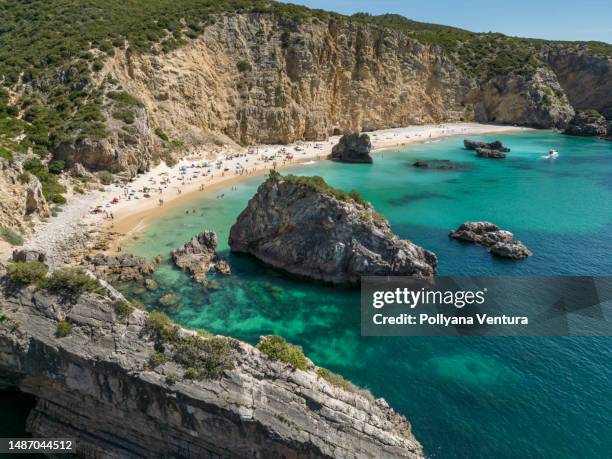 cliff and rocks on the beach in sesimbra - hill range stock pictures, royalty-free photos & images