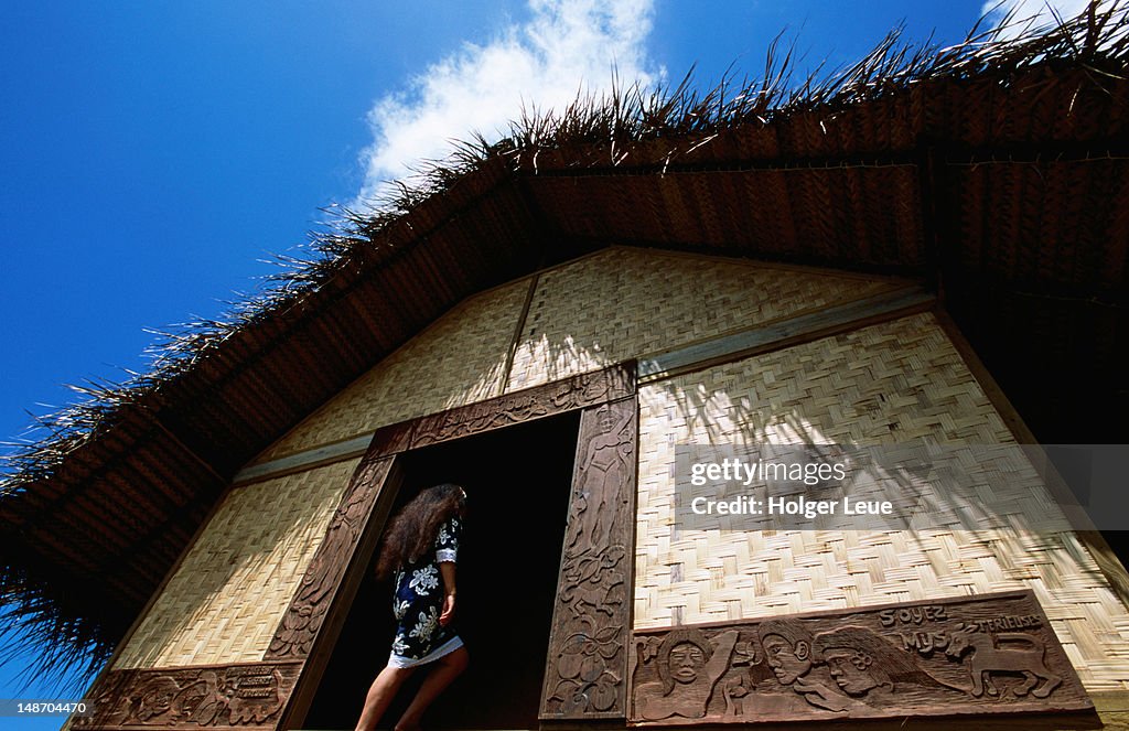 Woman entering Gauguin's house of pleasure.