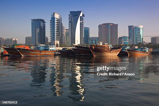 cargo ships at dhow wharfage on dubai creek. - dhow stock pictures, royalty-free photos & images