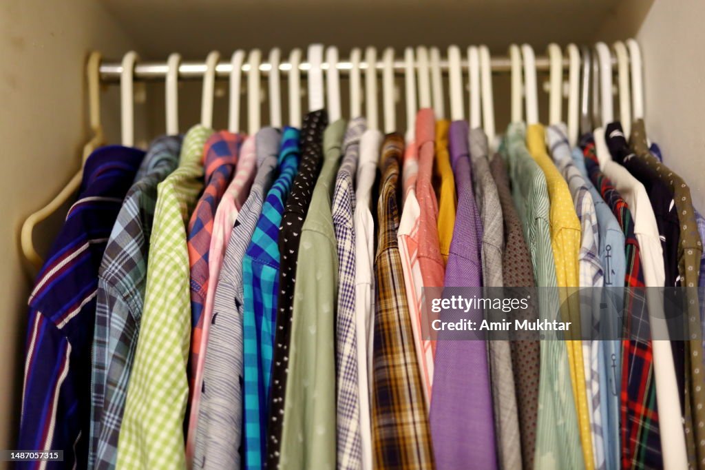 Multicolor shirts hanging on hangers for sale.
