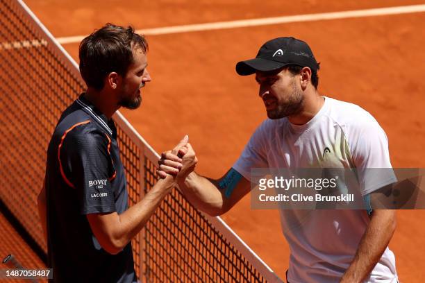 Daniil Medvedev shakes hands with Aslan Karatsev after the Men's Singles Fourth Round match on Day Nine of the Mutua Madrid Open at La Caja Magica on...
