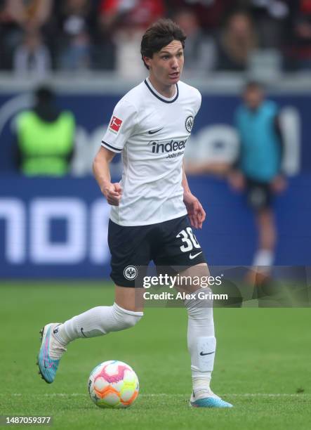 Paxten Aaronson of Eintracht Frankfurt controls the ball during the Bundesliga match between Eintracht Frankfurt and FC Augsburg at Deutsche Bank...