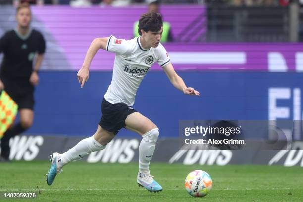 Paxten Aaronson of Eintracht Frankfurt controls the ball during the Bundesliga match between Eintracht Frankfurt and FC Augsburg at Deutsche Bank...