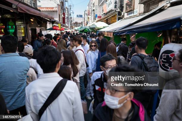 Tourists shop at Tsukiji Outer Market on May 2, 2023 in Tokyo, Japan. Starting from April 29 to May 7, people across Japan take a consecutive holiday...
