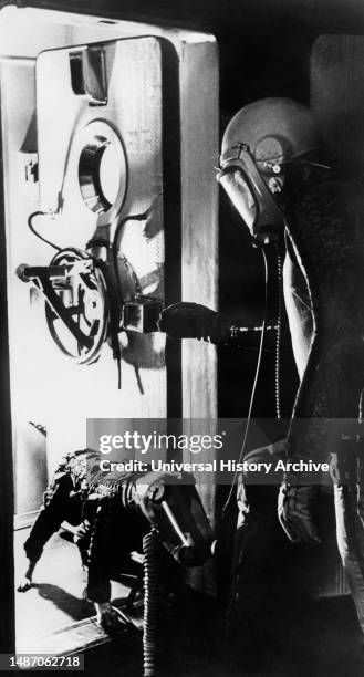 Russia, a dog and an astronaut enter a pressure chamber for training, 1959.