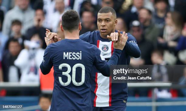 Kylian Mbappe of PSG celebrates his goal with Lionel Messi during the Ligue 1 Uber Eats match between Paris Saint-Germain and FC Lorient at Parc des...