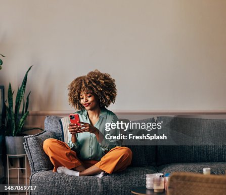 A Happy Beautiful Woman Texting On Her Mobile Phone While Relaxi A Happy Beautiful Woman Texting On Her Mobile Phone While Relaxi