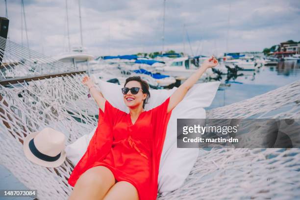 smiling woman in hammock enjoying her summer vacation - sozopol bulgaria stock pictures, royalty-free photos & images