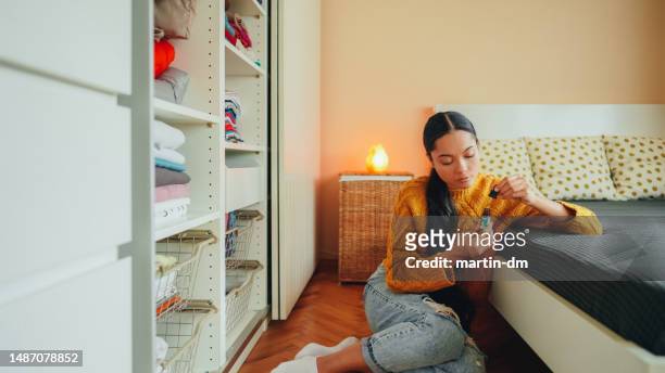 millennial at home using cbd oil for anxiety - cbd oil stock pictures, royalty-free photos & images