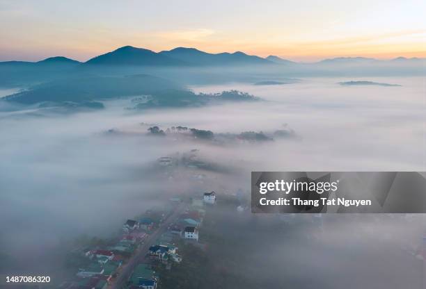 village on misty mountain at dawn - ariel view - destroyed city stock pictures, royalty-free photos & images
