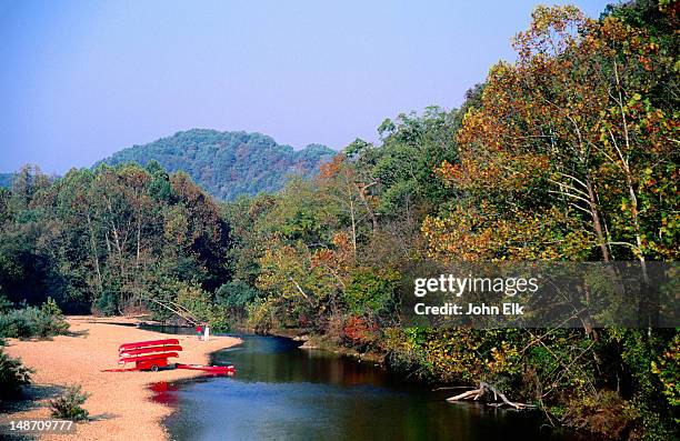 canoes on bank of jack's fork river, ozarks national scenic riverways. - ozark mountains stockfoto's en -beelden