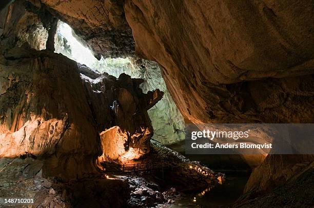 interior chamber with river in clearwater cave. - gunung mulu national park stock pictures, royalty-free photos & images