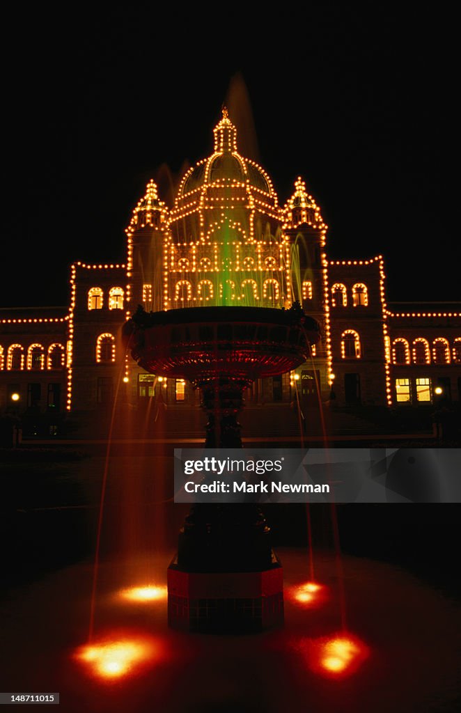 Victoria's impressive Parliament Building illuminated at night. The building faces directly onto Inner Harbour and was built between 1893 and 1902.