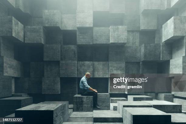 confused man sitting in cube shaped room - geometric maze stock pictures, royalty-free photos & images