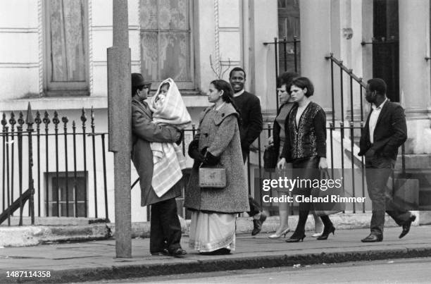 People of Black and Asian ethnicity at a bus stop in Britain, March 25th 1965.