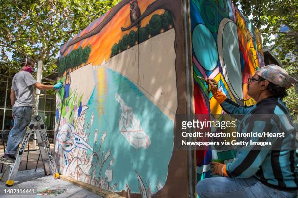 Max Guarnaccia, left, and Amol Saraf work on their individual murals as part of Earth Day Houston activities at Discovery Green Monday, April 19,...