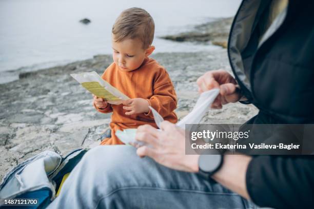 picnic by the sea father and son - wet wipe stock pictures, royalty-free photos & images