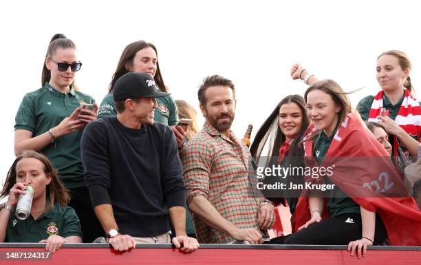 Rob McElhenney, Co-Owner of Wrexham, and Ryan Reynolds, Co-Owner of Wrexham, look on as they celebrate with players of Wrexham Women during a Wrexham...