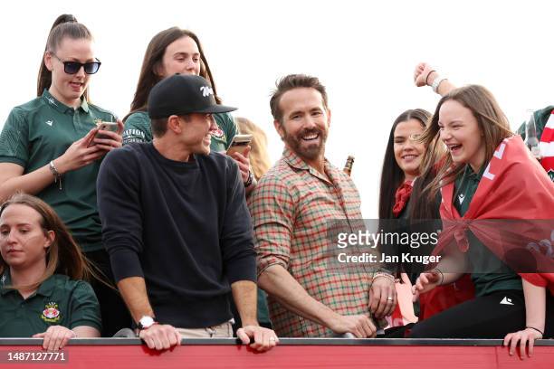 Ryan Reynolds, Co-Owner of Wrexham, and Rob McElhenney, Co-Owner of Wrexham, celebrate with players of Wrexham Men and Women during a Wrexham FC Bus...