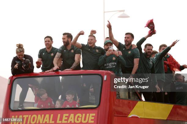 Ben Tozer, Ollie Palmer, Paul Mullin, Elliot Lee and Ben Foster of Wrexham celebrate during a Wrexham FC Bus Parade following their Title Winning...