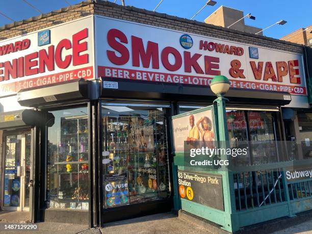 Howard Smoke and Vape shop and subway entrance on Queens Boulevard, Rego Park, Queens, New York.