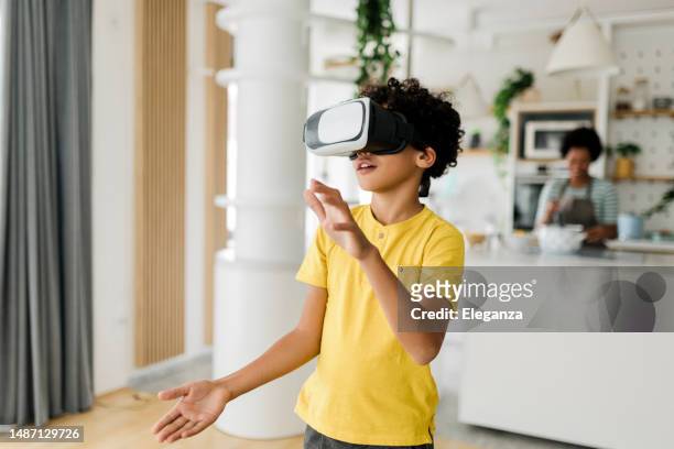 boy having fun while his mother cooking - vr headset kid stock pictures, royalty-free photos & images