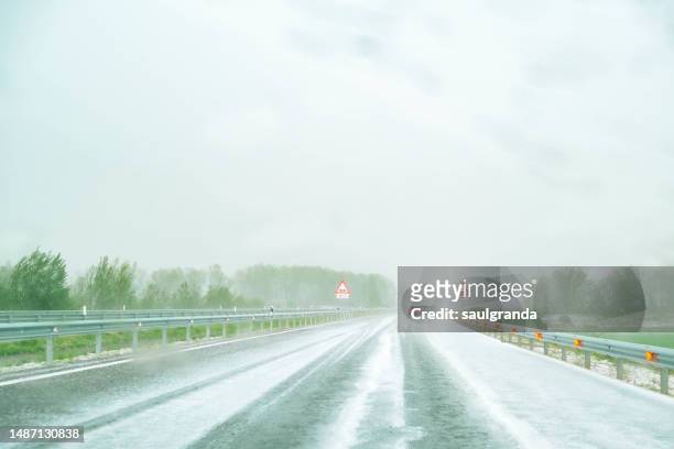 hailstorm seen from the car on a highway - hailstorm stock pictures, royalty-free photos & images