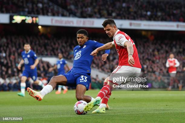 Granit Xhaka of Arsenal crosses the ball whilst under pressure from Wesley Fofana of Chelsea during the Premier League match between Arsenal FC and...