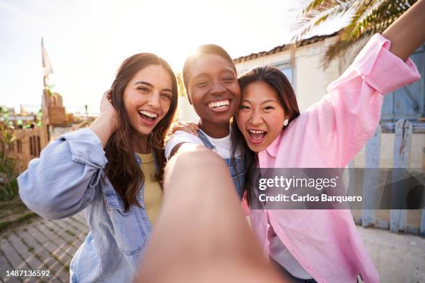 point of view of three women taking a photo using phone outdoors. - girlfriends stock pictures, royalty-free photos & images