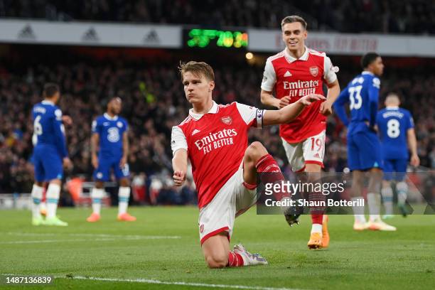 Martin Odegaard of Arsenal celebrates with teammates after scoring the team's second goal during the Premier League match between Arsenal FC and...