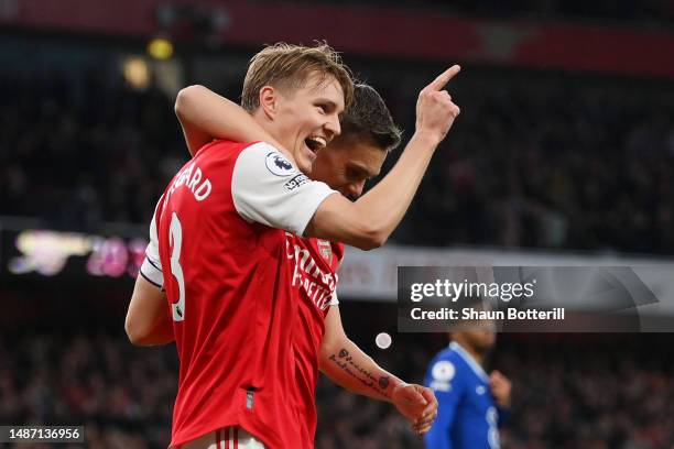 Martin Odegaard of Arsenal celebrates with teammate Leandro Trossard after scoring the team's second goal during the Premier League match between...