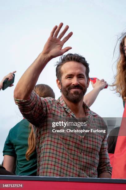 Ryan Reynolds, Co-Owner of Wrexham Football Club celebrates with players of Wrexham Men's and Women's sides during a Wrexham FC bus parade following...