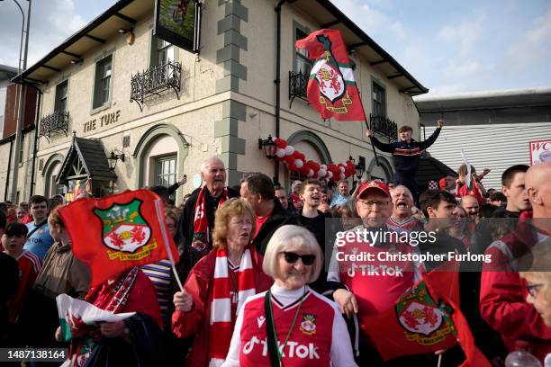 Wrexham Football Club fans celebrate during a bus parade following their respective title winning seasons for their Men and Women's sides in the...