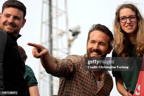 Ryan Reynolds, Co-Owner of Wrexham Football Club celebrates with players of Wrexham Men's and Women's sides during a Wrexham FC bus parade following...