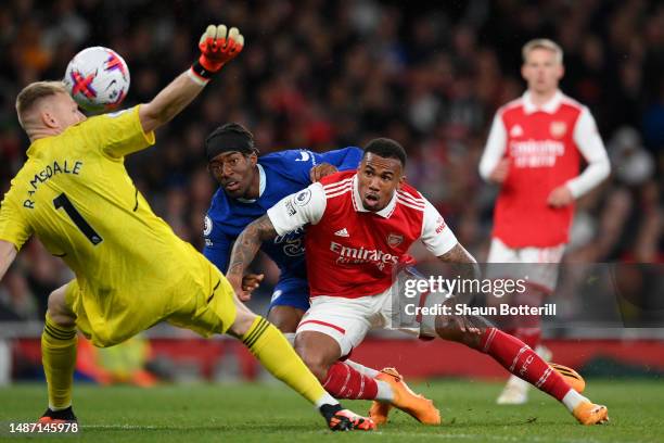 Noni Madueke of Chelsea scores the team's first goal whilst under pressure from Gabriel of Arsenal as Aaron Ramsdale fails to make save during the...