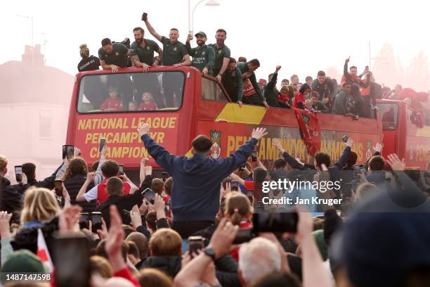 General view as players of Wrexham celebrate in front of fans outside the The Turf Hotel during a Wrexham FC Bus Parade following their Title Winning...