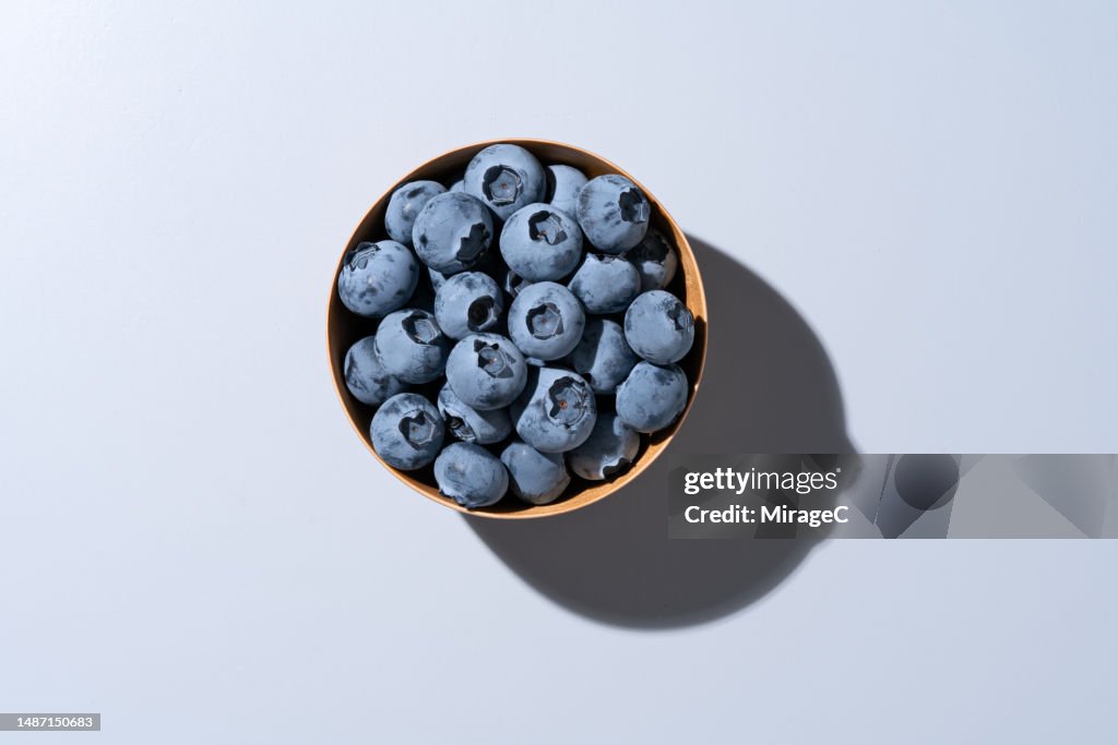 Fresh Blueberries in Wooden Bowl on Grey Background