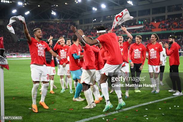 Amadou Haidara of RB Leipzig celebrates with teammates after the team's victory in the DFB Cup semifinal match between Sport-Club Freiburg and RB...