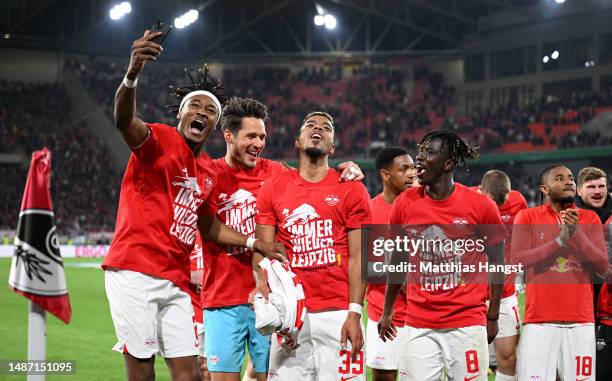 Mohamed Simakan, Janis Blaswich, Benjamin Henrichs and Amadou Haidara of RB Leipzig celebrate after the team's victory in the DFB Cup semifinal match...