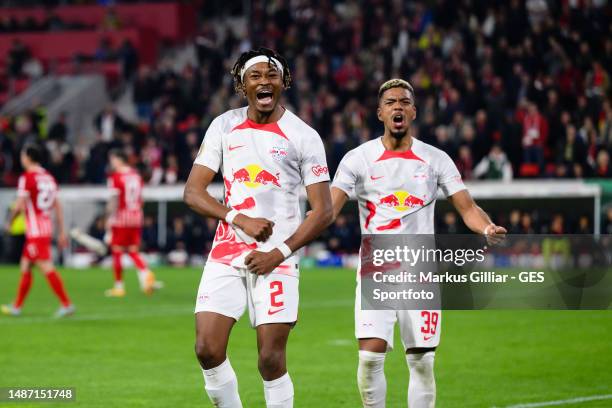 Mohamed Simakan and Benjamin Henrichs of Leipzig celebrates after scoring the team's fifth goal during the DFB Cup semifinal match between Sport-Club...