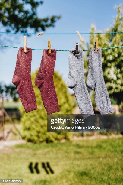 close-up of clothes drying on clothesline - striped socks stock pictures, royalty-free photos & images