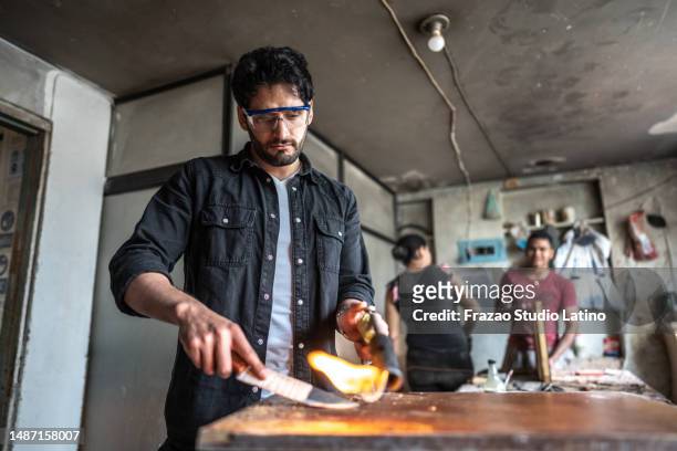 mid adult man working using blow torch at carpentry - blow torch stock pictures, royalty-free photos & images