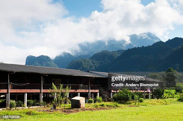 newly built longhouse in batu bungan to resettle iban nomadic tribespeople. - longhouse stock-fotos und bilder
