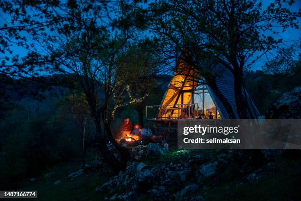 photo of wooden cabin house during dusk - hut mountains stock pictures, royalty-free photos & images