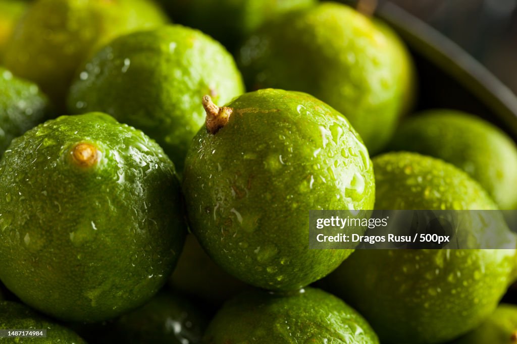 Raw Green Organic Key Limes in a Bowl,Romania