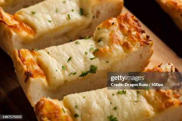 toasted cheese and garlic bread with parsley,romania - garlic bread stockfoto's en -beelden