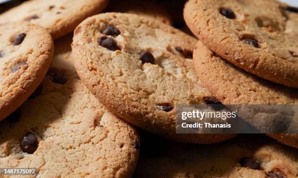 stack of chocolate chip cookies - chocolate chip cookie stock pictures, royalty-free photos & images